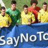 Belgium and Argentine players and referees pose with a "Say No to Racism" banner during a quarter-final football match.