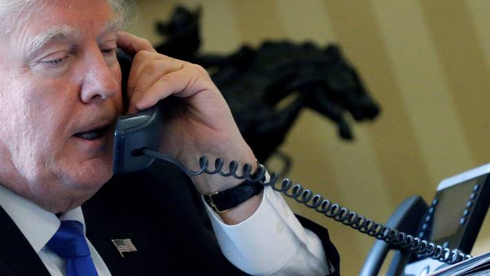 President Donald Trump speaks by phone with Russia's President Vladimir Putin in the Oval Office.