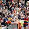 Leading by example: Crows player Jenna McCormick celebrates with fans after more than 53,000 packed the Adelaide Oval for the AFLW grand final.