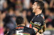 Jubilation: Nathan Cleary is swamped by Dallin Watene-Zelezniak after kicking the winning field goal against the Tigers.