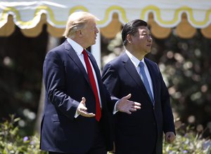 President Donald Trump and Chinese President Xi Jinping walk together at Mar-a-Lago, Friday, April 7, 2017, in Palm Beach, Fla.