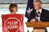 An Adani protester takes to the stage during Prime Minister Scott Morrison's speech at the Valley Chamber of Commerce ...