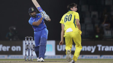 India's Rohit Sharma plays a shot as Australia's Jhye Richardson looks on.