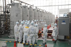 File - The IAEA mission team studies a water purification system that removes radioactive elements from water. Fukushima, Japan, 11 February 2015.