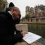 Man makes a drawing of the Notre Dame cathedral after the fire in Paris. Experts are assessing the blackened shell of Paris' iconic Notre Dame cathedral to establish next steps. Photo: AP Photo/Christophe Ena