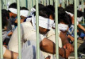 Iranian police put Afghan refugees inside cages, on public display