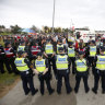 Police stand between far-right and anti-racism protesters at a rally in Melbourne in January this year.