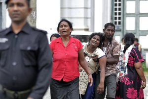 Relatives of a blast victim grieve outside a morgue in Colombo, Sri Lanka, Sunday, April 21, 2019.