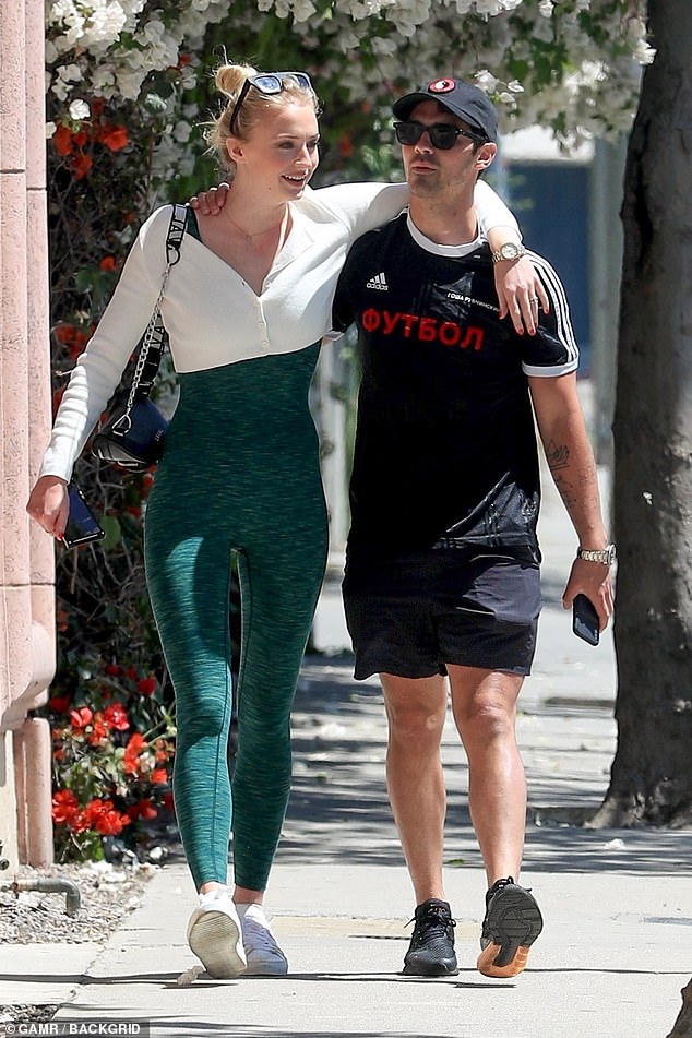 So happy together: The 23-year-old actress flaunted her fabulous figure in a green one-piece while Joe, 29, opted for shorts and shirt as the couple grabbed a table at West Hollywood hotspot Alfred's coffee shop