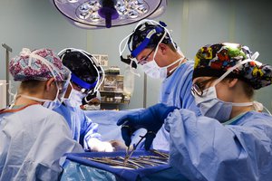 Sailors aboard the Navy hospital ship USNS Comfort perform surgery in an operating room aboard the ship in San Juan, Puerto Rico, Oct. 31, 2017