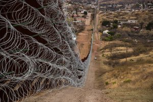 File  -  Layers of Concertina are added to existing barrier infrastructure along the US - Mexico border near Nogales, AZ, February 4, 2019.