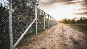 File - Barbed-wire can be seen on the border barrier between Hungary and Serbia.