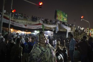 In this Thursday, April 18, 2019 photo, Amal al-Zein, an activist who was detained under former Sudanese President Omar al-Bashir, attends a protest in Khartoum, Sudan