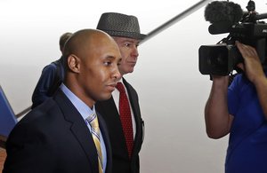 File - Mohamed Noor, left, waits with his attorney, Tom Plunkett, arrives at the Hennepin County Government Center for a hearing Tuesday, May 8, 2018, in Minneapolis.