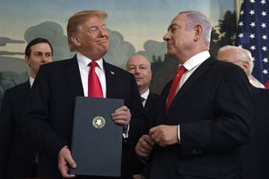 President Donald Trump smiles at Israeli Prime Minister Benjamin Netanyahu, right, after signing a proclamation in the Diplomatic Reception Room at the White House in Washington, Monday, March 25, 2019.