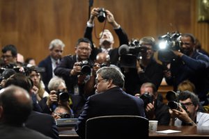 Attorney General William Barr is photographed as he sits down to testify before the Senate Judiciary Committee on Capitol Hill in Washington, Wednesday, May 1, 2019.