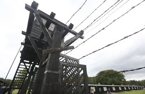 In this July 18, 2017 photo the wooden main gate leads into the former Nazi German Stutthof concentration camp in Sztutowo, Poland.