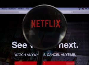 Netflix logo on a computer screen with a magnifying glass