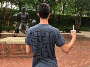 David Belnap, a sophomore at the University of North Carolina at Charlotte, displays a t-shirt in Charlotte, N.C., Wednesday, May 1, 2019, in support of Riley Howell, a classmate who was killed while confronting a gunman inside a classroom on Tuesday.