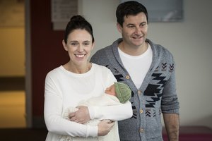 New Zealand Prime Minister Jacinda Ardern, left, with her partner Clarke Gayford, holds their newly born baby girl, Neve, at Auckland Hospital on Sunday, June 24, 2018.