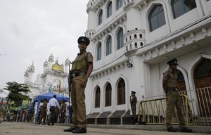 Sri Lankan police officers stand guard outside a Sufi Islamic mosque during Friday prayers in Colombo, Sri Lanka, Friday, May 3, 2019