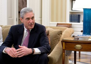 File - FBI Director Robert Mueller is seen in the Oval Office, Washington. President Barack Obama and Vice President Joe Biden met with senior advisors in the Oval Office to discuss the shooting tragedy in Aurora, Colorado, July 20, 2012.