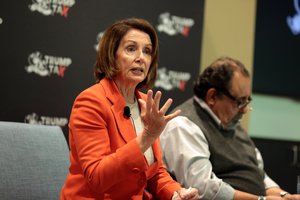 Minority Leader Nancy Pelosi speaking with attendees at a Trump Tax Town Hall hosted