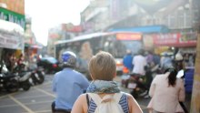 Woman in busy street with backpack