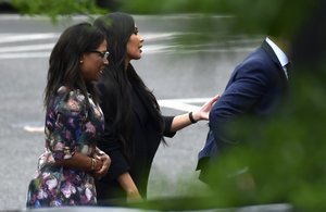 Kim Kardashian, second from left, leaves the West Wing of the White House in Washington, Wednesday, May 30, 2018, with her attorney Shawn Chapman Holley, left.