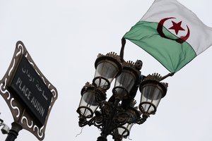 A demonstrators waves an Algerian flag during a protest in Algiers, Algeria, Friday, May 3, 2019.