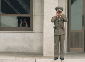 File - North Korean soldiers observe the South at the truce village of Panmunjom in the demilitarized zone (DMZ) that separates the two Koreas since the Korean War, north of Seoul.