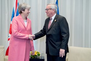 Handshake between Jean-Claude Juncker, President of the EC and Theresa May, British Prime minister during his participation at the EU-League of Arab States summit in Sharm El-Sheikh, Egypt,  25/02/2019