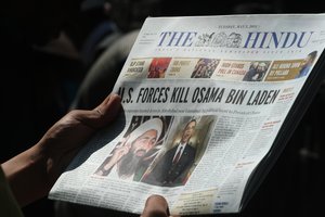 File - Kashmiri people read newspapers with cover stories of Osama bin Laden's death, in Srinagar, May 3, 2011.