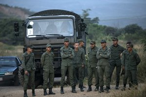 Soldiers stand at the entrance of the Tienditas International bridge that connects Venezuela with Colombia, in Urena, Venezuela, Thursday, Feb. 21, 2019