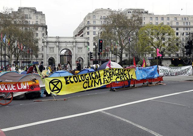 The road is blocked by demonstrators during a climate protest at Marble Arch in London, Tuesday, April 16, 2019