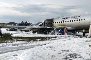 The Sukhoi SSJ100 aircraft of Aeroflot airlines is covered in fire retardant foam after an emergency landing in Sheremetyevo airport in Moscow, Russia, Sunday, May 5, 2019.