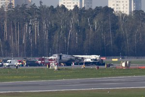 The Sukhoi SSJ100 aircraft of Aeroflot Airlines, center in the background, is seen after an emergency landing in Sheremetyevo airport outside Moscow, Russia, Monday, May 6, 2019