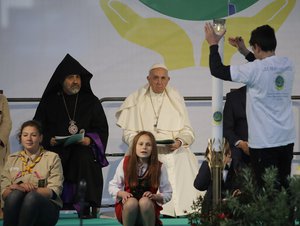 A candle is lit as a symbol of peace as Pope Francis starts a prayer for peace in the presence of various religious confessions in Nezavisimost square, in Sofia, Bulgaria, Monday, May 6, 2019.