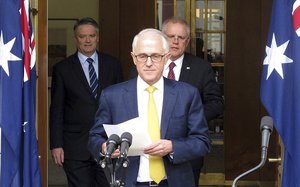 Australia's Finance Minister Mathias Cormann, left, Prime Minister Malcolm Turnbull, center, and Treasurer Scott Morrison arrive to address media at Parliament House in Canberra, Australia, Wednesday, Aug. 22, 2018.