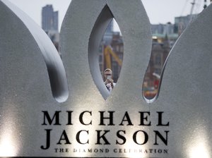 A fan of the former King of Pop Michael Jackson takes pictures whilst celebrating Jacksons Diamond Birthday Celebration with the installation of a giant 13 foot jewelled crown at London's iconic Southbank in London, Wednesday, Aug. 29, 2018.