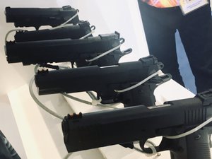 A row of black handguns on display at a Gun Expo. Taken on November 2018.