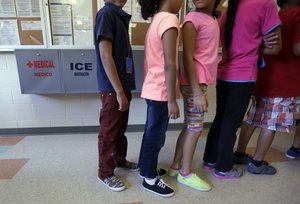 In this Sept. 10, 2014, file photo, detained immigrant children line up in the cafeteria at the Karnes County Residential Center