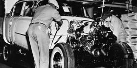 General Motors workers assemble an engine