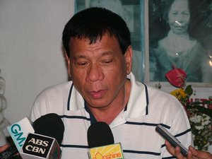 Davao City Mayor Rodrigo Duterte answers questions from reporters during a press conference at the Roman Catholic Cemetery in Davao City, Philippines.