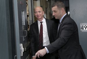 Amazon CEO Jeff Bezos, left, leaves the Yale Club in New York, Wednesday, Feb. 20, 2019.