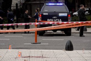 Police stand near the crime scene where Argentine lawmaker Hector Olivares was seriously injured and another man killed after they were shot at from a moving vehicle near the congressional building, in Buenos Aires, Argentina, Thursday, May 9, 2019