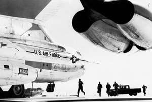 Members of a Strategic Air Command B-52 combat crew race for their always ready-and-waiting B-52 heavy bomber.  Fifty percent of the SAC bomber and tanker force is on continuous ground alert, ready to be enroute to target within the warning time provided by the ballistic missile early warning system.  One of the bomber's two hound dog missiles is shown in the foreground.  (U.S. Air Force photo)