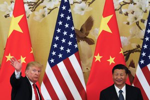 U.S. President Donald Trump waves next to Chinese President Xi Jinping after attending a joint press conference at the Great Hall of the People, Thursday, Nov. 9, 2017, in Beijing.