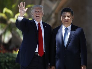 In this April 7, 2017, file photo, President Donald Trump and Chinese President Xi Jinping pause for photographs at Mar-a-Lago, in Palm Beach, Fla.