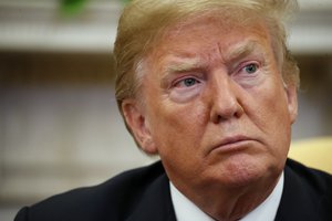 President Donald Trump sits with Joshua Holt, who was recently released from a prison in Venezuela, in the Oval Office of the White House, Saturday, May 26, 2018, in Washington.